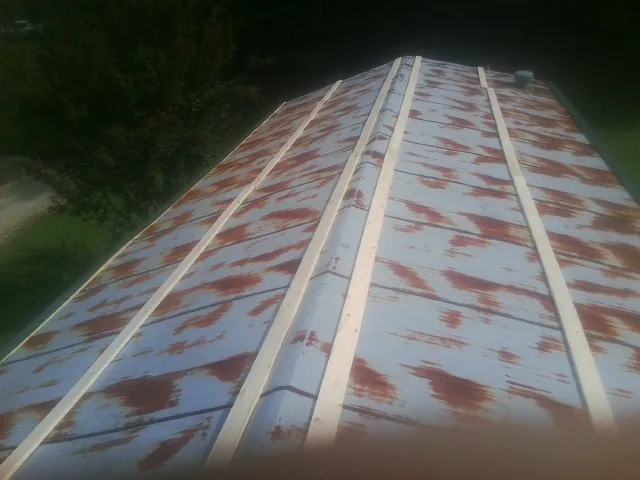 Rusted metal roof panels with new wood purlins before replacement — Storm Damage Roof Repair in Blythewood by Roofing Brothers