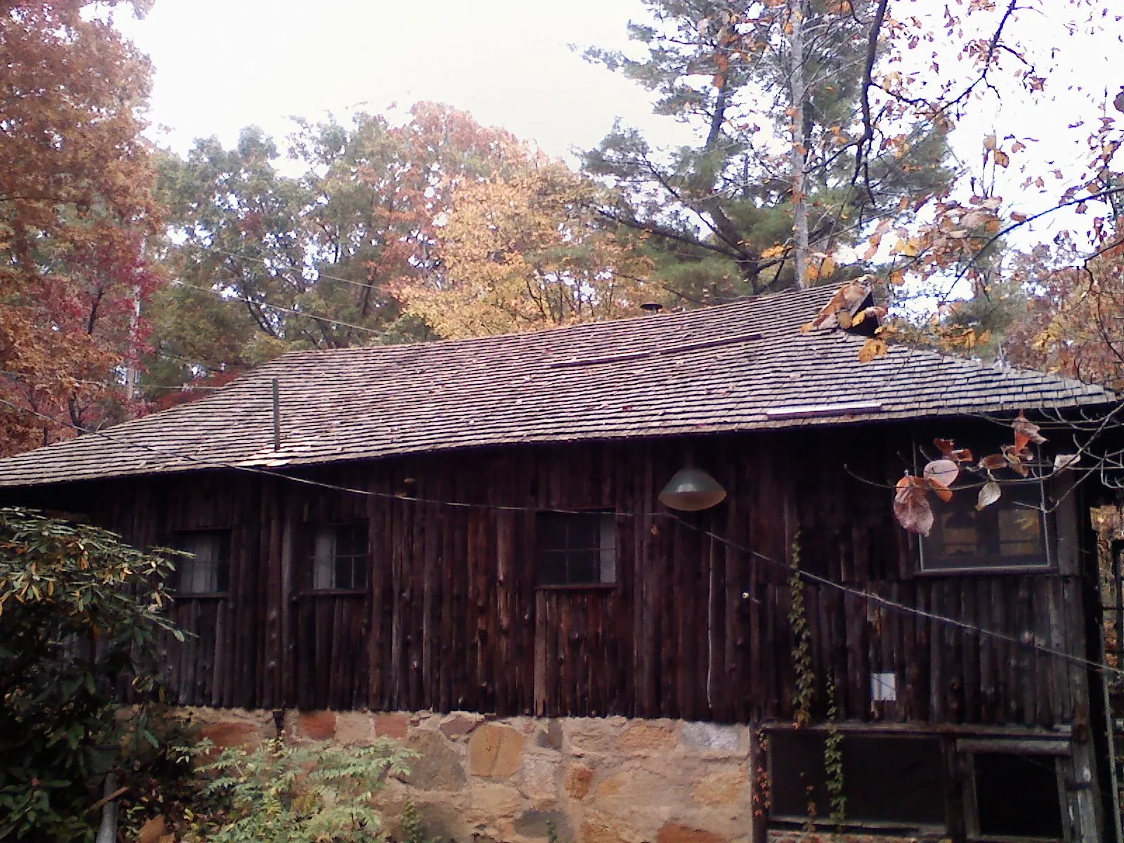 Weathered wood shake roof on a rustic board sided cabin in Blythewood